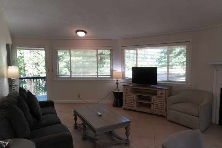 Bright living room with a sofa, armchair and coffee table