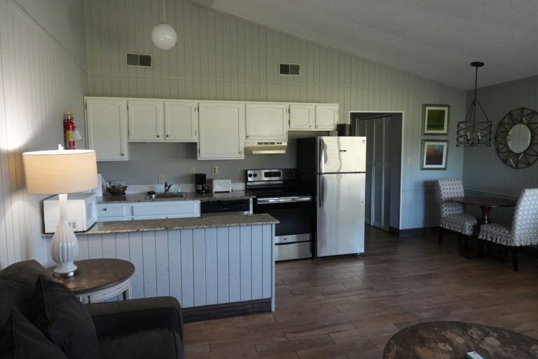 Kitchen with white cabinets and a small dining nook beside it