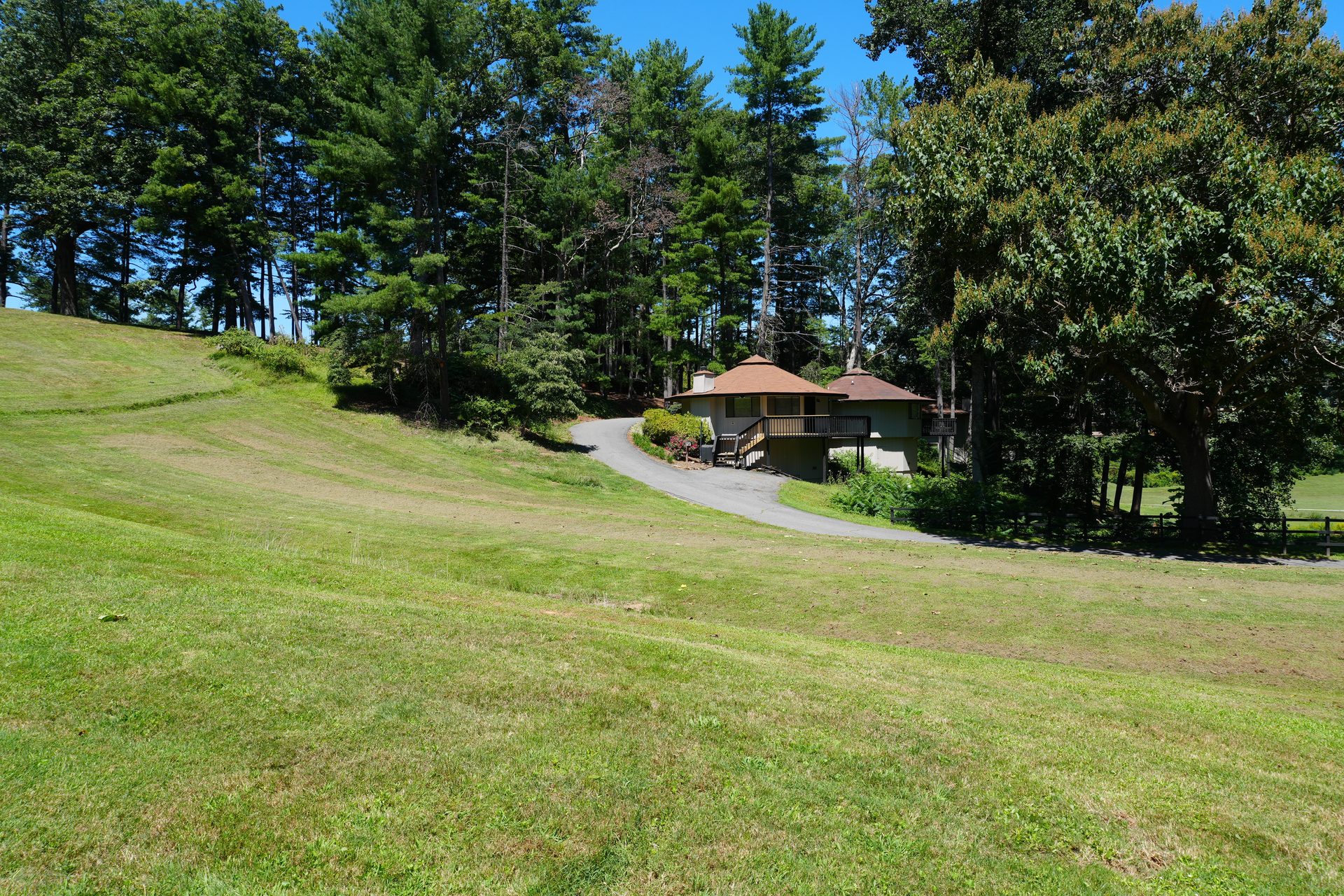 Octagonal villas at the edge of the pines, above a sweeping lawn