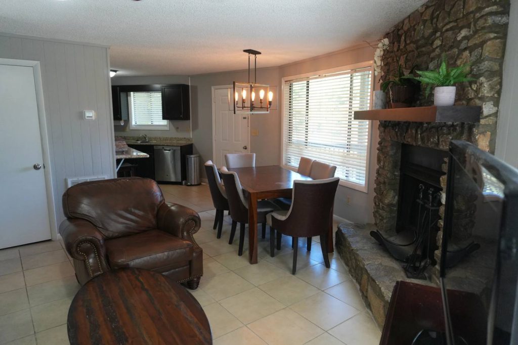 Living and dining room with a stone fireplace