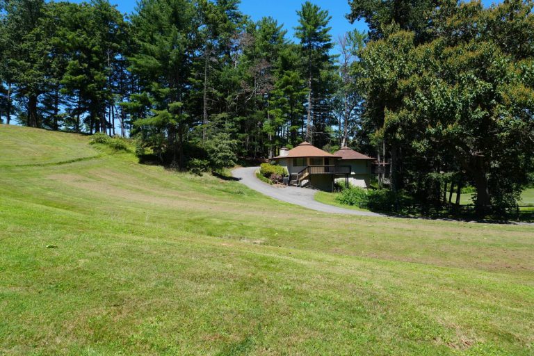 Villas at the edge of the pines, above a sweeping lawn