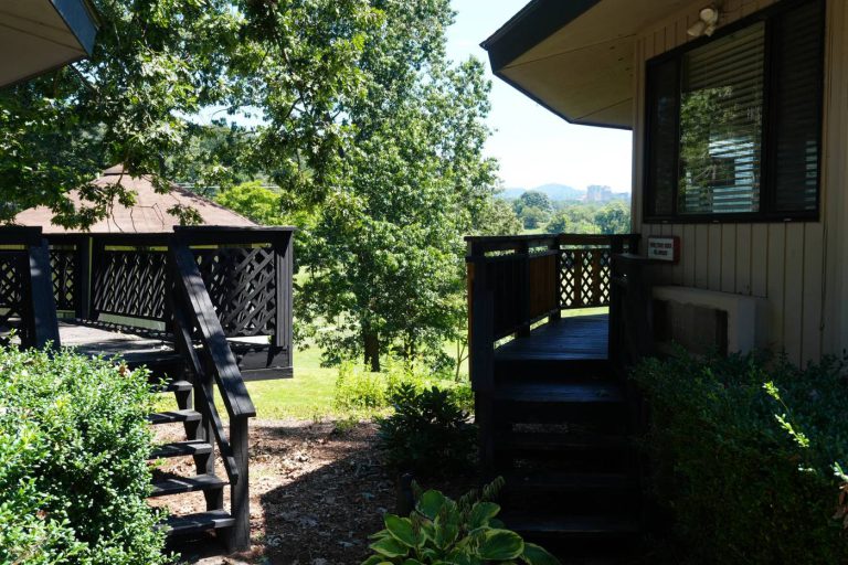 Walkway between villas with the Asheville skyline beyond