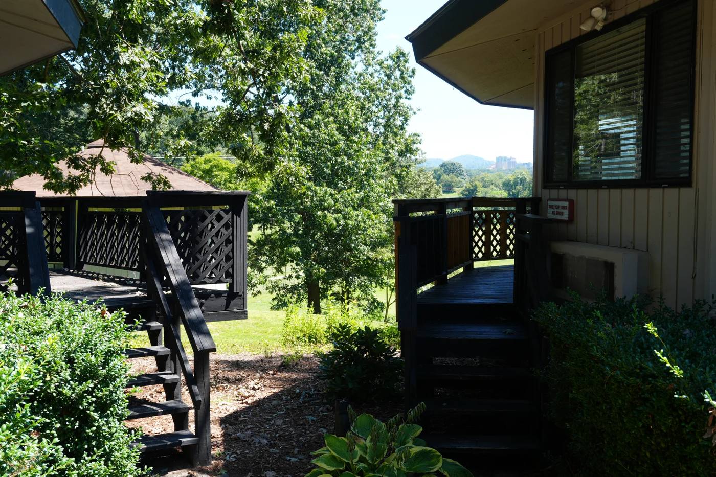 Walkway between villas with the Asheville skyline beyond
